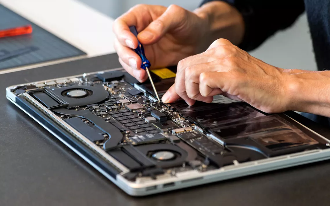 Technician repairing a laptop